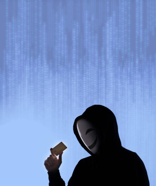 istock Hacker man and credit cards in hand. Represent credit cards personal data stolen by anonymous man in Black hood shirt. Credit cards data security and Cyber crime digital. Money transection unsecured. 1453306041