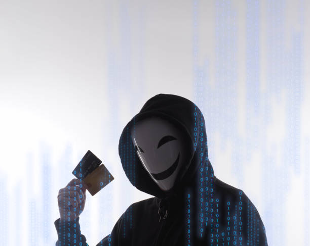istock Hacker man and credit cards in hand. Represent credit cards personal data stolen by anonymous man in Black hood shirt. Credit cards data security and Cyber crime digital. Money transection unsecured. 1453306134