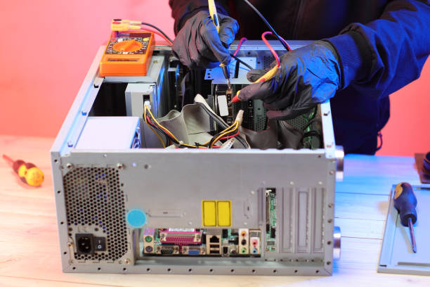 istock checking the voltage with an ammeter in an old computer on the table 1453306266