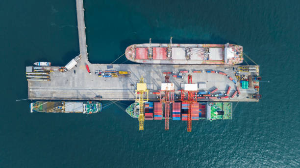 istock Cargo container Ship load container box to Cargo Ship at Shipyard Bridge of Container Sea port at sunset. ship under the crane Sea Port service logistics and transportation. 1453306635