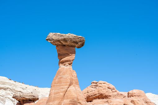 Toadstool Hoodoos in the heat of the desert near the city of Kanab in Utah, USA. Seen a hot summer day with blue sky in the background.