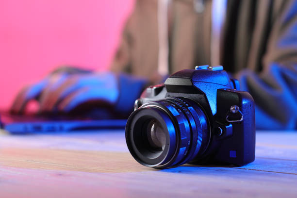 istock digital slr camera with old lens on table with person 1453308226