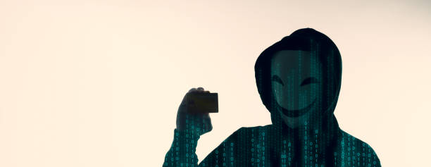 istock Hacker man and credit cards in hand. Represent credit cards personal data stolen by anonymous man in Black hood shirt. Credit cards data security and Cyber crime digital. Money transection unsecured. 1453309199