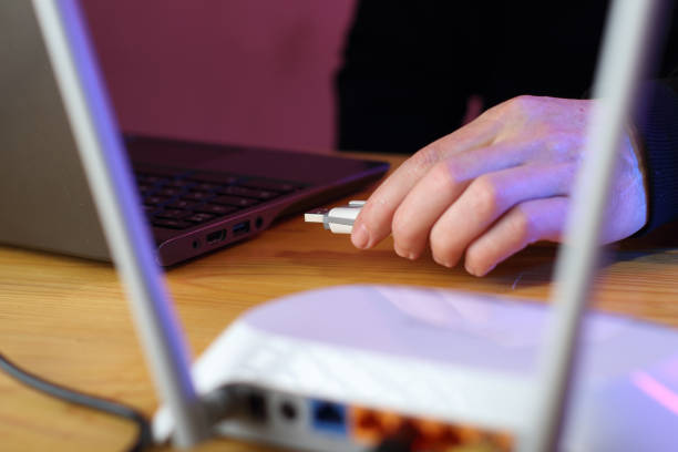 istock inserting a gsm modem into a laptop by a person 1453309702