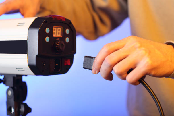 istock a person in the background inserting a power cord 1453310695