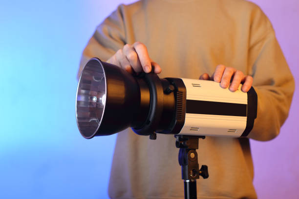 istock person in the background holding a studio flash with a pot 1453310701