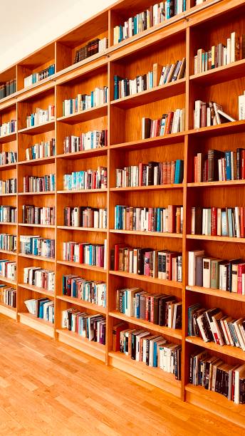 istock Library, parquet floor and and fully packed wooden shelves 1453311146