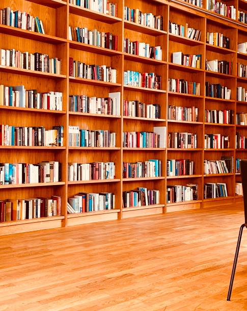 istock Library, parquet floor and and fully packed wooden shelves 1453311159
