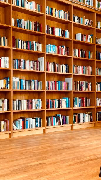 istock Library, parquet floor and and fully packed wooden shelves 1453311164