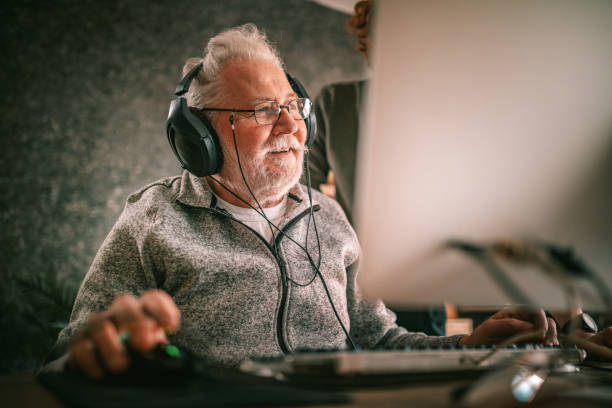 istock grandfather and grandson sitting around table at home and using computer 1453311247