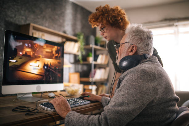 istock grandfather and grandson sitting around table at home and using computer 1453311420