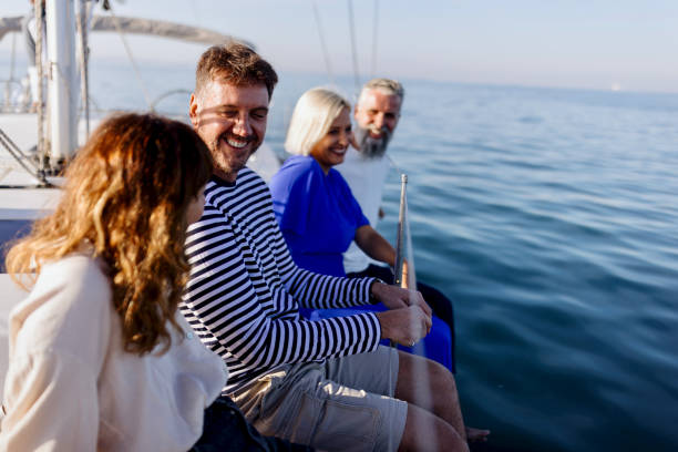 istock Smiling couple talking and relaxing while sailing yacht 1453313286