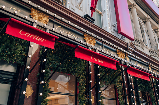 London, UK - December 26, 2022: Christmas decorations on the facade of the Cartier store on New Bond Street, one of the most famous streets for luxury shopping in London.