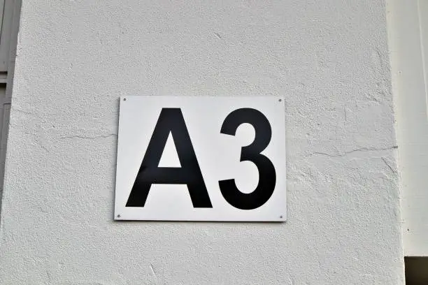 A closeup shot of the entrance gate sign and number A3 of the stadion's white wall