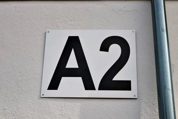 A closeup shot of the entrance gate sign and number A2 of the stadion's white wall