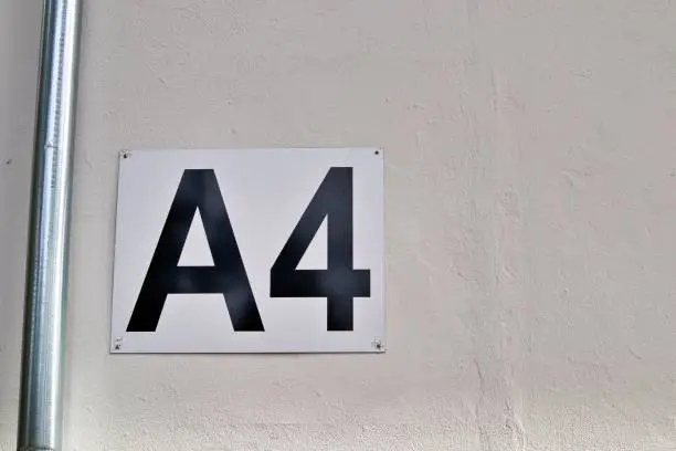 A closeup shot of the entrance gate sign and number A4 of the stadion's white wall
