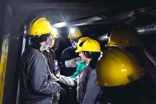 Group of young miners in a subway mine.