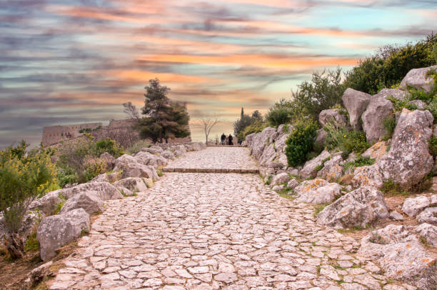 istock Couple walking on stone path at sunset .Greece 1453318039