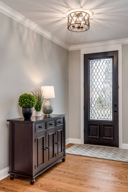 istock An entryway with a wood and glass front door. 1453318152