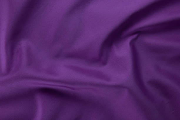 istock smooth white cotton Texture, curved silk background, pattern. Texture of white silk fabric. Beautiful emerald soft silk 1453319423