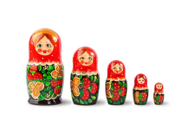 Photo of wooden Russian dolls in red, isolate on a white background