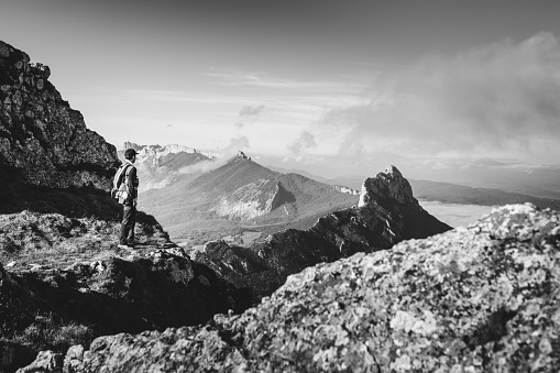 Happy hiker winning reaching life goal, success, freedom and happiness, achievement in mountains.  Navarre, Spain. Monochrome version.