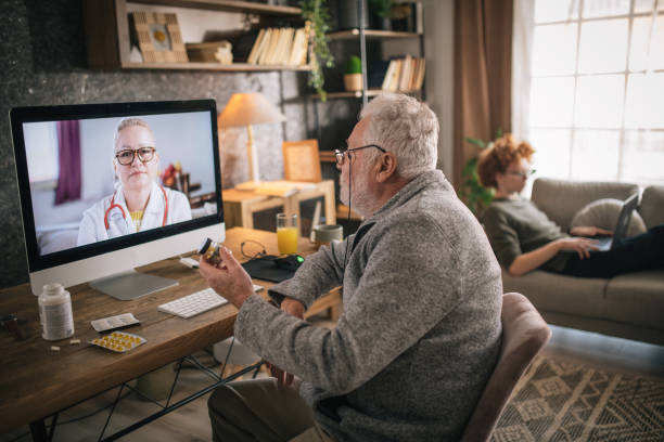 istock senior man consulting with his doctor online 1453322472