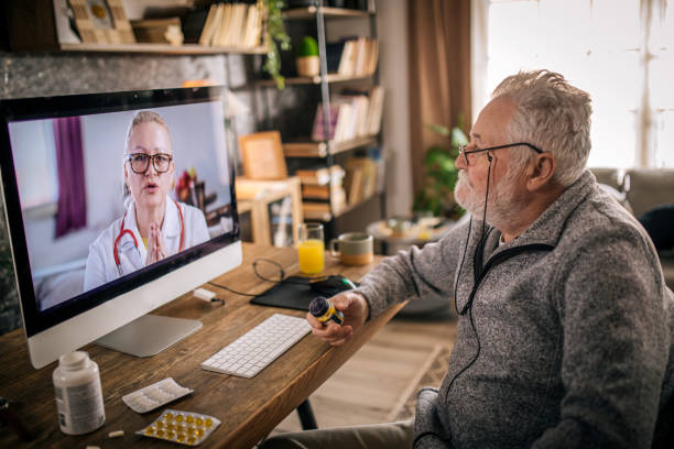 istock senior man consulting with his doctor online 1453322484