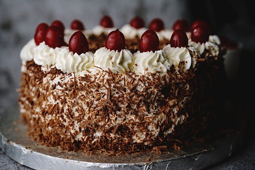 Homemade Black forest cake topped with fresh cherries, selective focus
