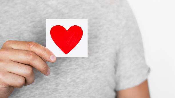 istock Man holding a red heart. Romantic man. Message. Love. The senses. 1453326409