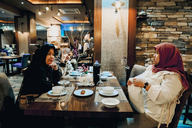 istock asian women enjoying dinner in restaurant 1453326508