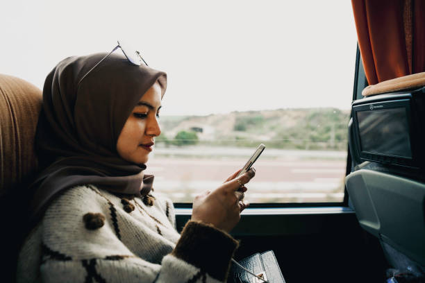 istock Woman inside a bus  on the phone 1453326520