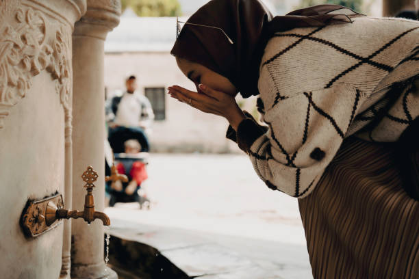 Muslim woman taking ablution for prayer