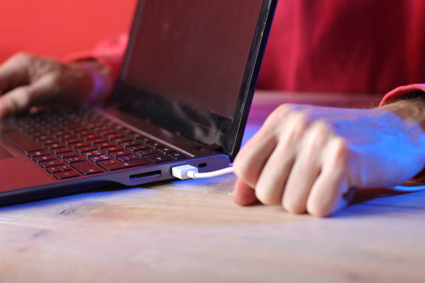 istock tearing out the usb cable from the laptop hands on the table 1453331193