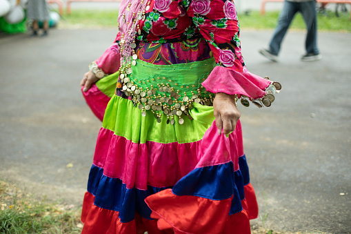 Folk costume. Party on street. Old-fashioned clothes. Bright colors on fabric.