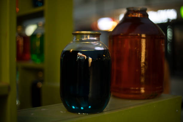 istock Cans on shelf with colored water. Interior details. Glass containers. 1453335745