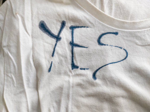 istock Writing Yes on T-Shirt with Ink 1453338932