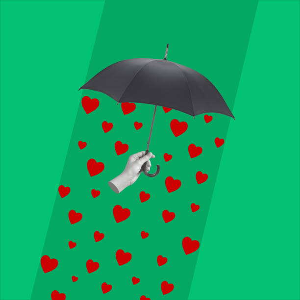 istock Hand holding an umbrella and rain from hearts. 1453340015