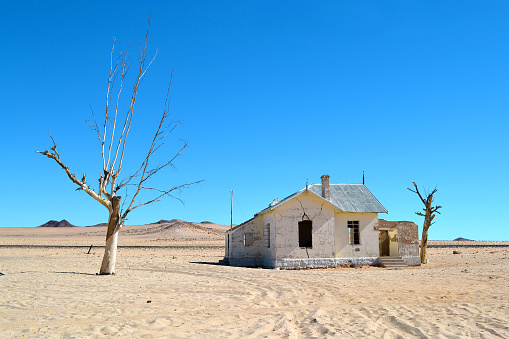 A railway station in Kolmanskop, stands abandoned in the desert, in the sand, Namibia.