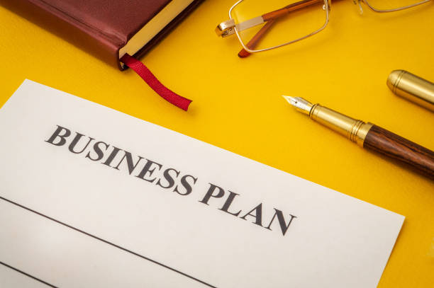 istock Blank form and pen for drawing up business plan on yellow table 1453341296