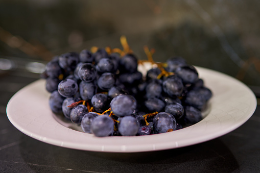 grape berries lie on a dark background in the kitchen