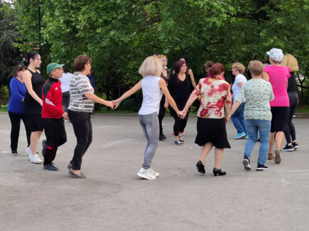 Varna, Bulgaria - May, 16, 2022: people in the park dancing a Bulgarian folk dance