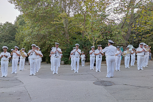 Varna, Bulgaria - September, 08,2022: military navy band in ceremonial white suits performs in the city park