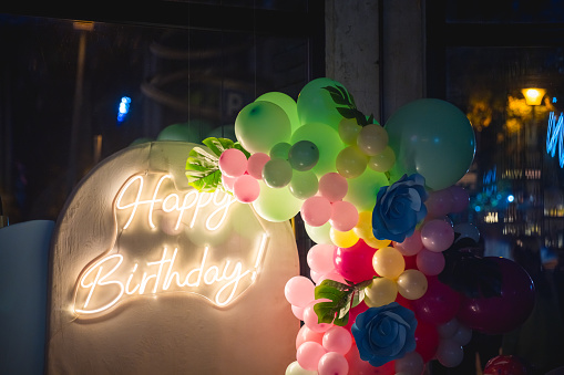 Neon Happy Birthday sign with ballons