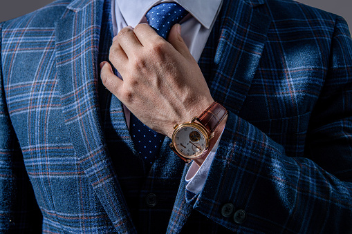 closeup of businessperson in wristwatch. businessperson wearing wristwatch. photo of businessperson wear wristwatch. businessperson in wristwatch and suit.