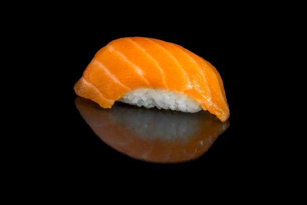 istock Salmon sushi isolated on a black background. 1453347562