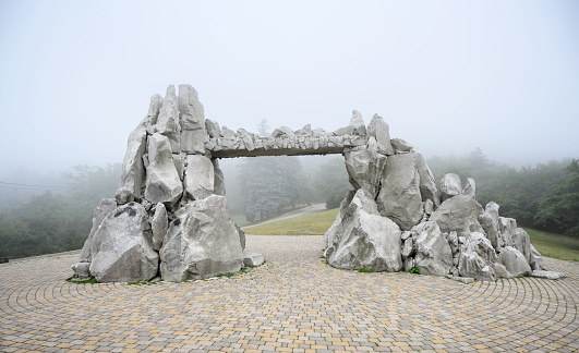 Mist in Pyatigorsk, Stavropol Krai, Russia. Foggy view of stone structure at Mashuk Mount slope. Misty scenery of road and forest. Theme of nature of Pyatigorsk, Caucasus, hike, tourism and travel.