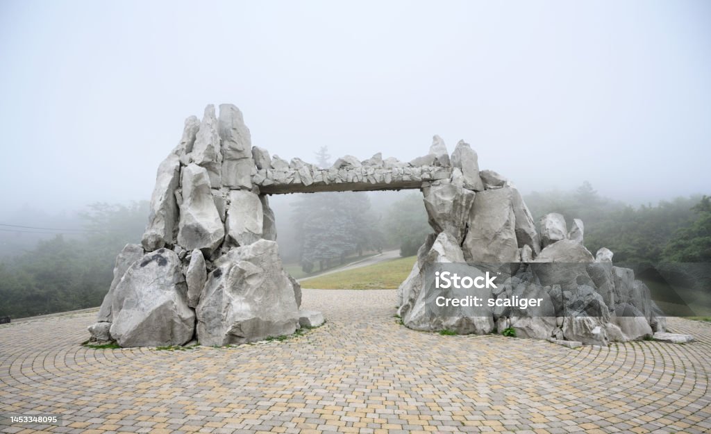 Mist in Pyatigorsk, Stavropol Krai, Russia Mist in Pyatigorsk, Stavropol Krai, Russia. Foggy view of stone structure at Mashuk Mount slope. Misty scenery of road and forest. Theme of nature of Pyatigorsk, Caucasus, hike, tourism and travel. Arch - Architectural Feature Stock Photo