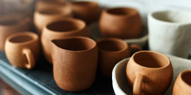 istock A close-up of various drying clay tableware on a shelf. A pottery studio concept. Craftmade dishes, bowls, pots, mugs of different colors. Cozy view. workshop with ceramic dishware 1453349960