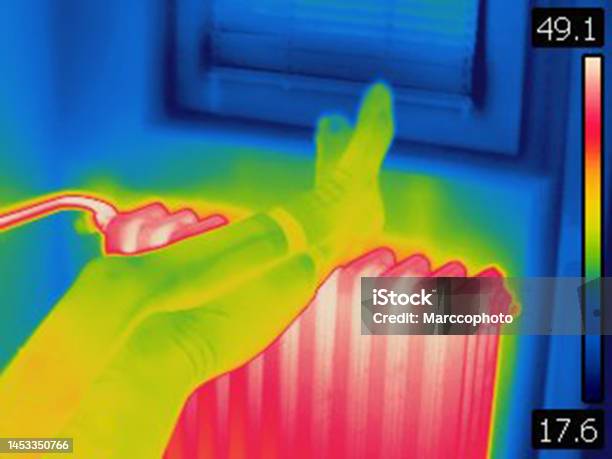 Thermal Image Of Female Legs On Hot Home Heating Radiator Stock Photo - Download Image Now
